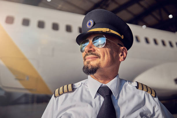 istock Bearded handsome man in pilots hat looking at the sunny sky 1278024163