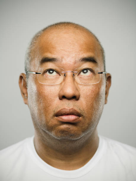 istock Portrait of a real chinese mature man with blank expression looking up 1278025802