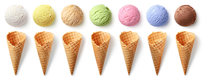 Row of different ice cream scoops and cones isolated on white background, top view. Vanilla, pistachio, strawberry, caramel, mango, blueberry and chocolate flavors