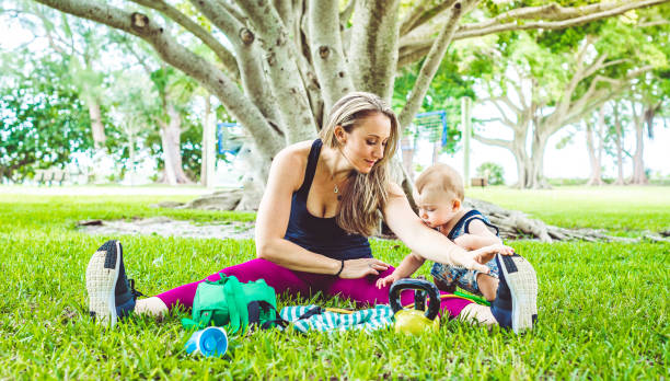 istock Attractive mother exercises outdoors with her toddler son 1278032333