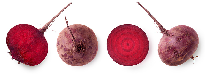 Whole and cut in half fresh beetroot isolated on white background, top view
