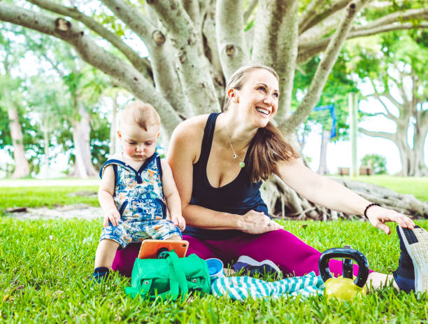 istock Happy mother exercises outdoors with her child in tow 1278033453