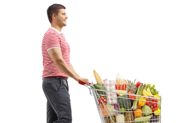istock Young man walking and pushing a full shopping cart 1278033666