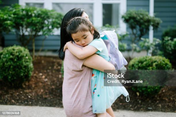 Girl Hugs Her Mother On First Day Of School Stock Photo - Download Image Now - Child, Anxiety, Embracing