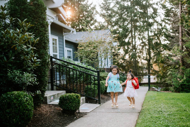 istock Back to School Sisters Hold Hands Wearing Backpacks 1278034171