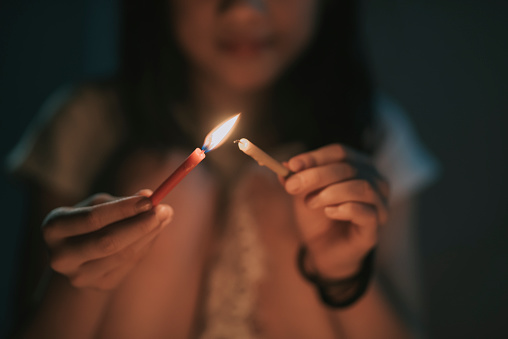 asian chinese young girl lighting up candle during mid autumn festival at night celebration