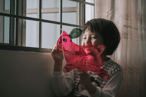 asian chinese young girl drawing on the rabbit shape chinese lantern preparing for mid autumn festival at night