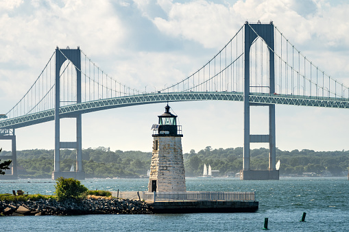 Summer day in Newport RI looking at the Goat Island Lighthouse with the Newport Bridge in the background