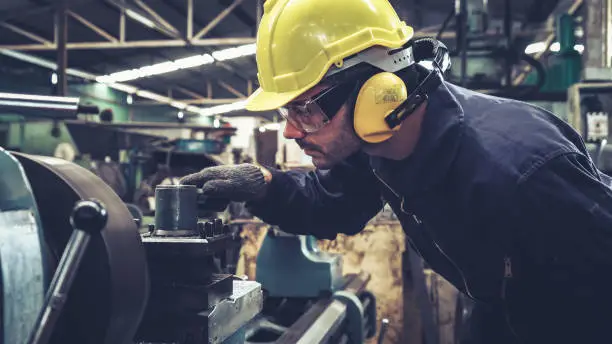 Photo of Smart factory worker using machine in factory workshop