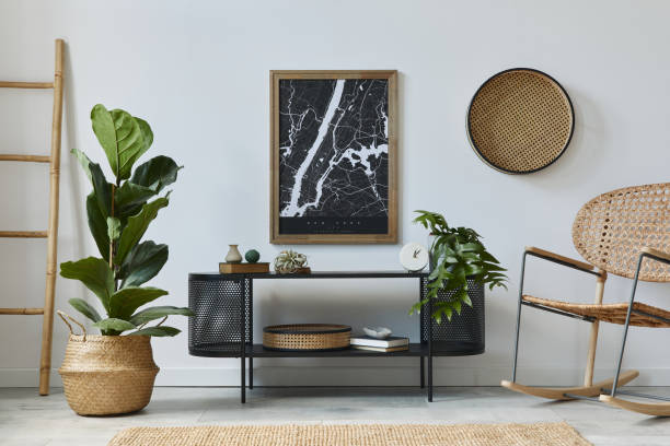istock Modern scandinavian living room interior with mock up poster frame, design commode, plants, rattan armchair, book and elegant accessories in stylish home decor. Template. 1278038335