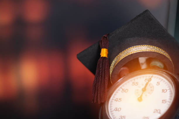 istock Abroad International Educational Program Concept : Graduation cap on top retro alarm clock with color background. Ideas for Times Studies lead to success in life. Back to School. 1278038617