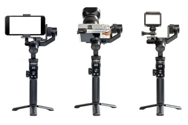 Group of video capture equipment are mounted on a 3-axis motor stabilizer for smooth video recording isolated on white background.