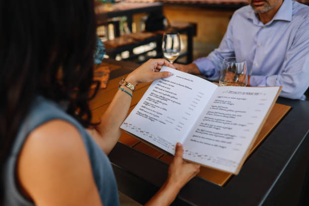 istock couple sitting in a restaurant, ordering food and drinks 1278039695