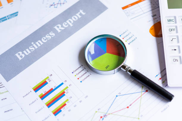 istock Magnifying glass on pie chart with statistics accounting info which including of many economic statistics business.  Business Concept 1278040268