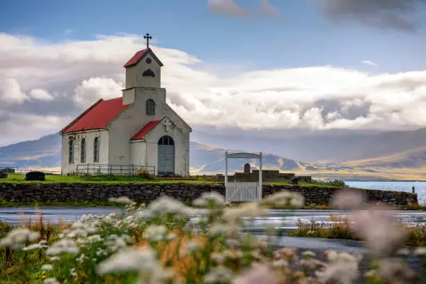 Photo of Innra-Holmskirkja church with a cemetery in Iceland