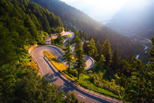 Maloja Pass road in Switzerland at sunset Aerial view of Maloja Pass road in Switzerland at sunset. This Swiss Alps mountain road is located in dense forests of the canton Graubunden. Hdr processed. maloja region stock pictures, royalty-free photos & images