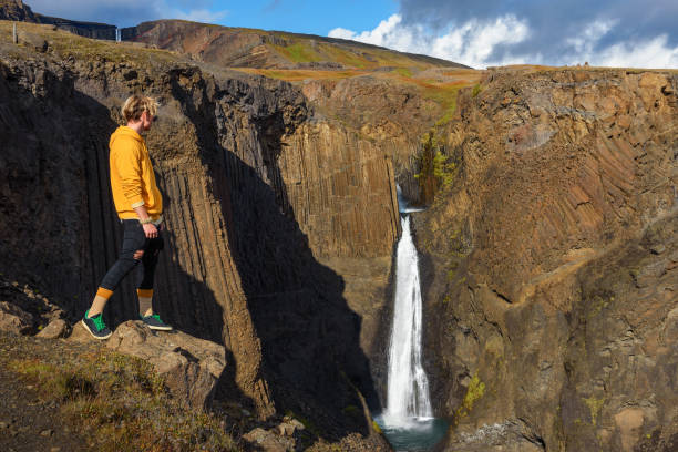 istock Young hiker standing at the Litlanesfoss waterfall in Iceland 1278040482