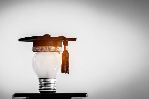 istock Education or Graduate study Creative concept: Hands holding light bulb with Graduated hat on gray background. Ideas with innovation creativity for Educational successs studies world. back to School 1278040705