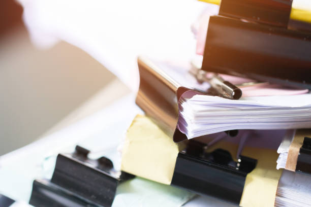 unfinished documents stacks of paper files on office desk for report papers, piles of unfinish sheet achieves with black clips. document is written presented. business offices busy concept. - unfinish imagens e fotografias de stock