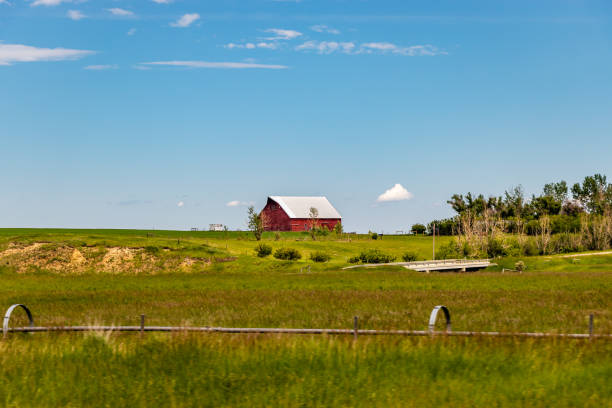 istock ed barn in a field. Nanton, Alberta, Canada 1278042648
