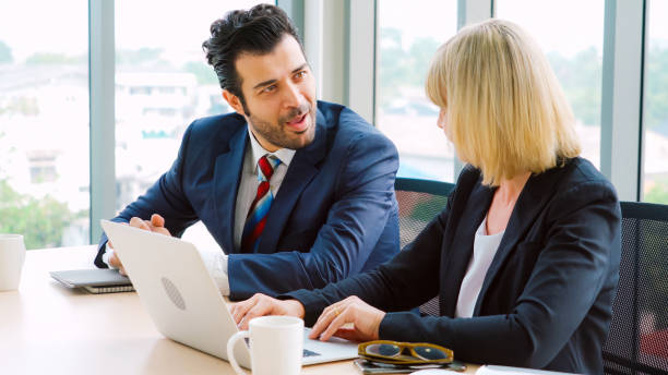 istock Two business people talk project strategy at office 1278043628