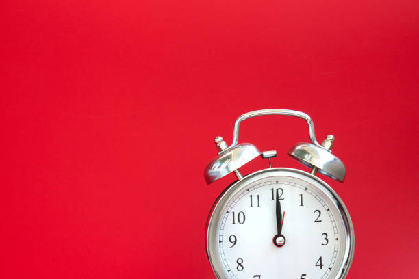istock Beautiful silver vintage alarm clock on a bright red background 1278045776