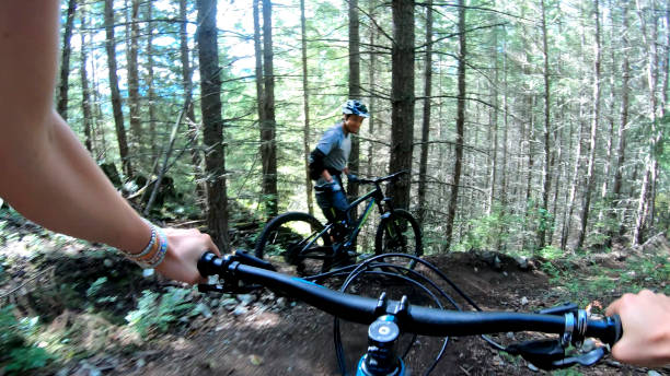 istock Female mountain biker rides along forested path 1278046324