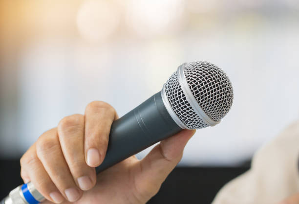 istock Seminar Speaking Conference Concept : Microphone of speech in seminar room or speaking conference hall light bokeh background. Speaker Business tedtalk is vocalized form of communication humans. 1278048637