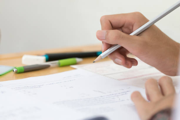 istock Woman Asian Hands Student testing in exam on exercise taking at high school or university in test room and Writing document exams classroom, back to school and evaluation measurement in education 1278050774