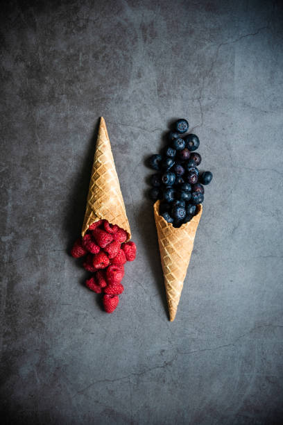 istock Fresh berries in waffle cones on dark stone background 1278051842