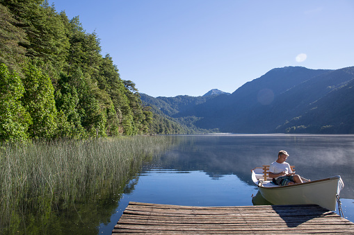 He uses digital tablet while mists swirl around him