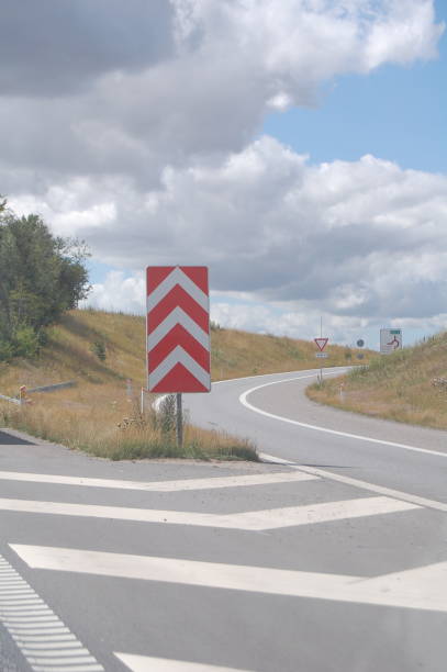 a right exit turn from a multiple lane highway and a dividing sign. - multiple lane highway sign exit sign leaving imagens e fotografias de stock