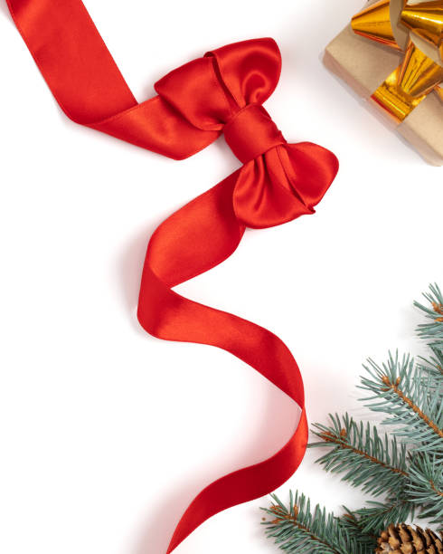 istock Branches of a Christmas tree, cones, a gift and a red bow on a white background, copy space. 1278052801