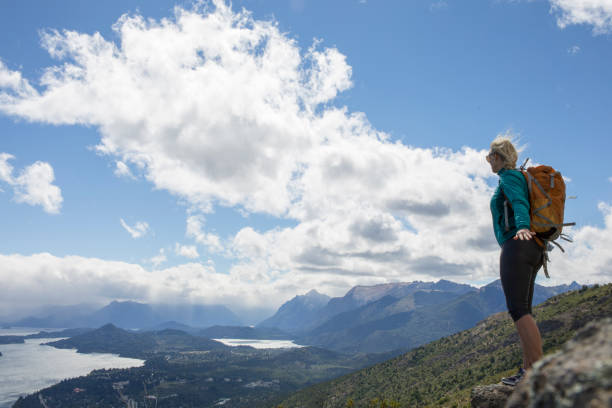 istock Female hiker pauses on rock summit 1278053490