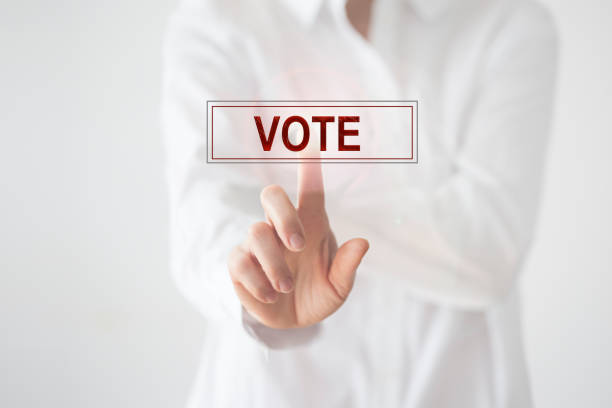 Vote - Woman hand pressing vote button on touch screen. Online vote concept.