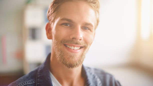 istock Handsome Stylish Young Man Looking at Camera and Smiling Charmingly. Blue Eyed Blonde Haired Young Adult Male with Stylishly Trimmed Beard and Gentleman Moustache. Close-up Portrait 1278053738