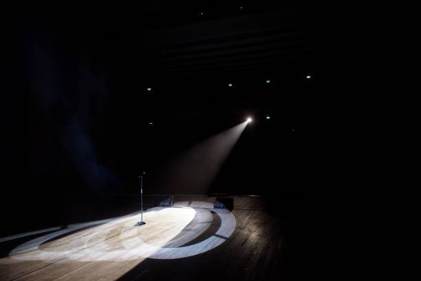 istock Microphone in a smoke on a dark background in the beam of light. 1278054198