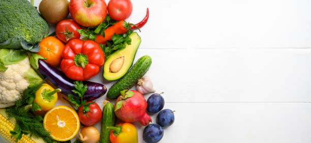 istock Various vegetables and fruits on the white wooden table, directly above, copy space. 1278055656