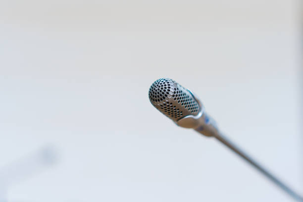 istock Microphone for speaker of speech on stage for speaking audience at seminar conference room, Mini mic event for lecture to audience university on white background 1278055748