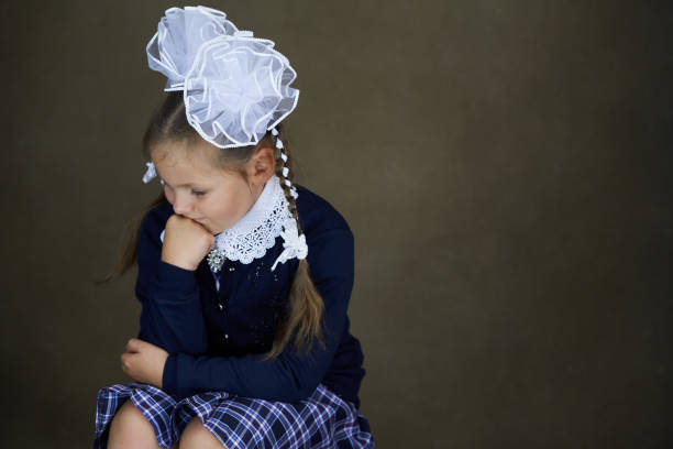istock Young girl in school uniform with hair bow. 1278056103