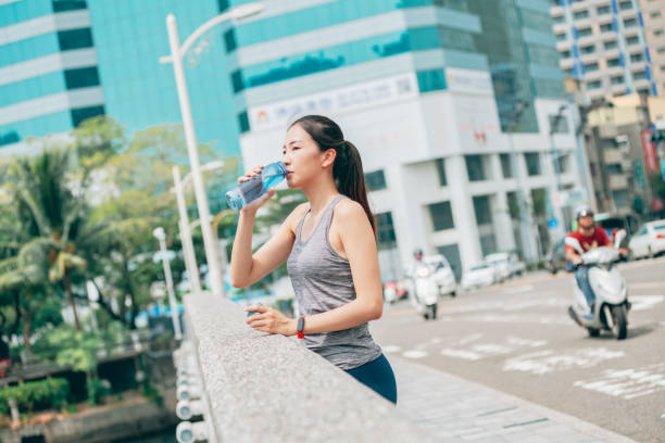 istock Female athlete drinking water 1278057803