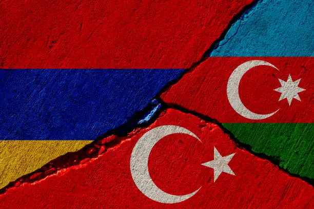 concrete wall with painted armenia, azerbaijan and turkey flags