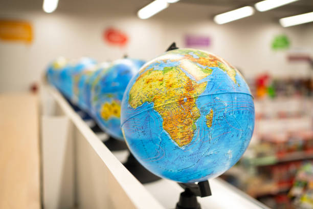 istock globes on shelf in store or in classroom. 1278063622