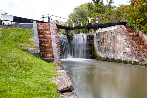 Overflowing lock gates on the Grand Union Canal in South Northamptonshire.