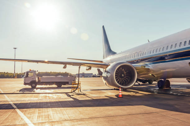 Airplane refueling, connected fuel hose under the fuel tank in the wing. Airplane refueling, connected fuel hose under the fuel tank in the wing air vehicle stock pictures, royalty-free photos & images