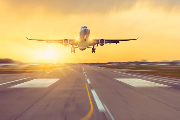 istock Airplane landing on runway speed, sunset on background. 1278067791