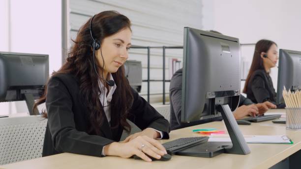istock Business people wearing headset working in office 1278070836
