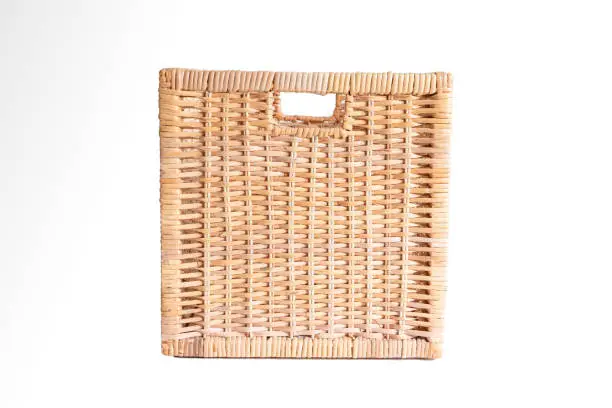 Photo of Brown cubic woven storage basket isolated on white front view
