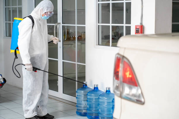 istock health care worker in white jumpsuit and protective face mask using spraying machine to disinfect virus pandemic.  Health care and midicine concept. New normal social distancing concept. 1278074190