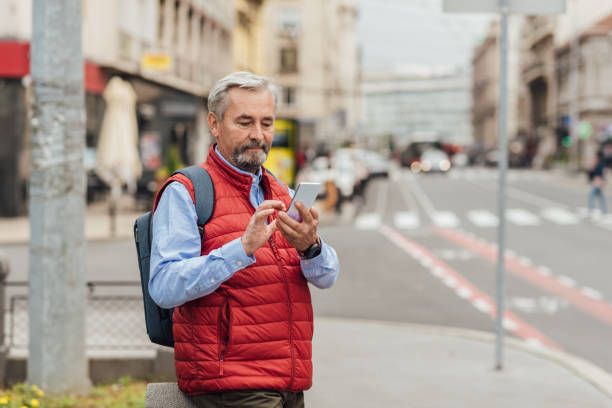 istock Senior man using phone on the street 1278077938